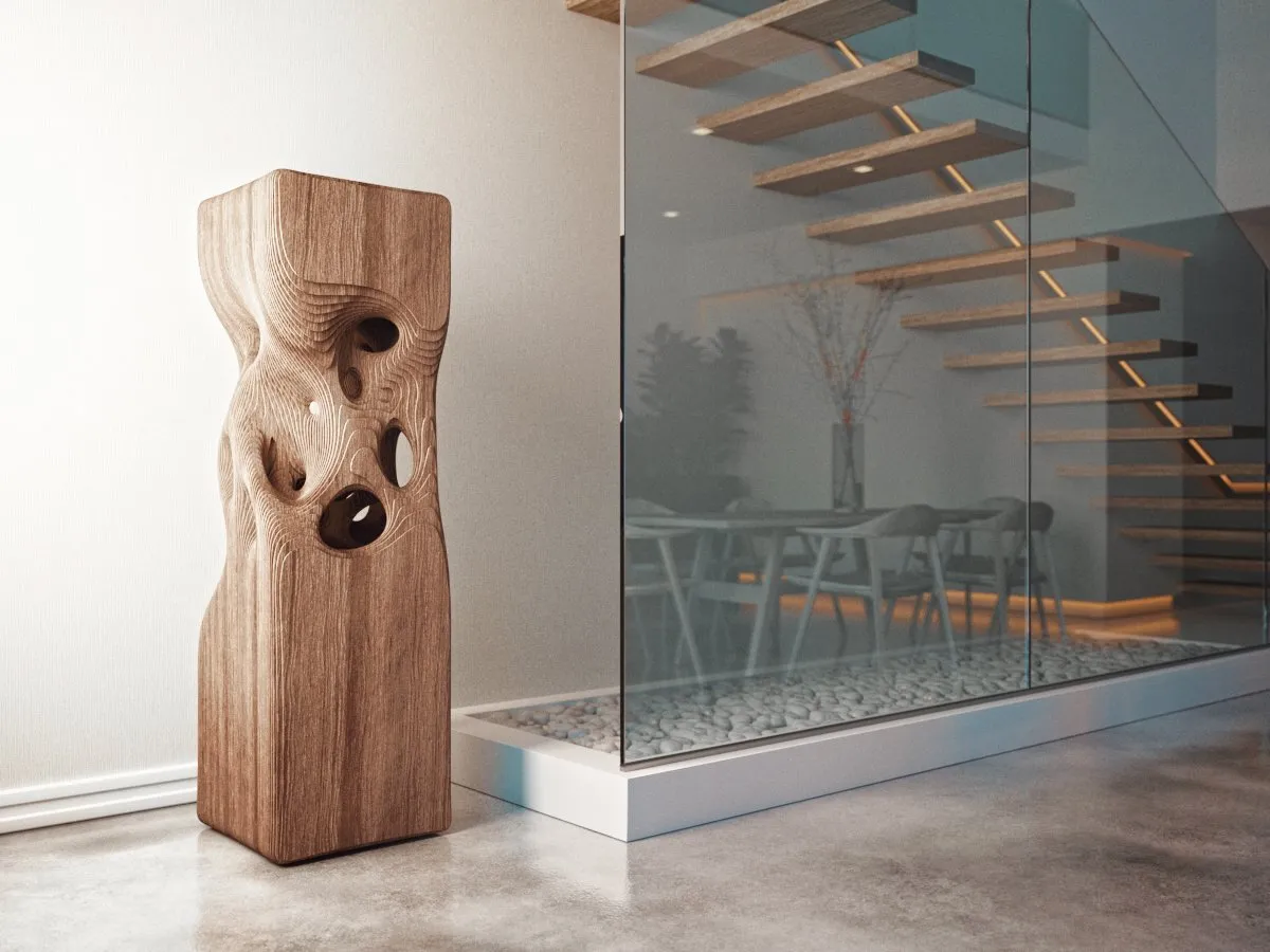 A carved wooden column with rounded openings stands in a bright modern interior.